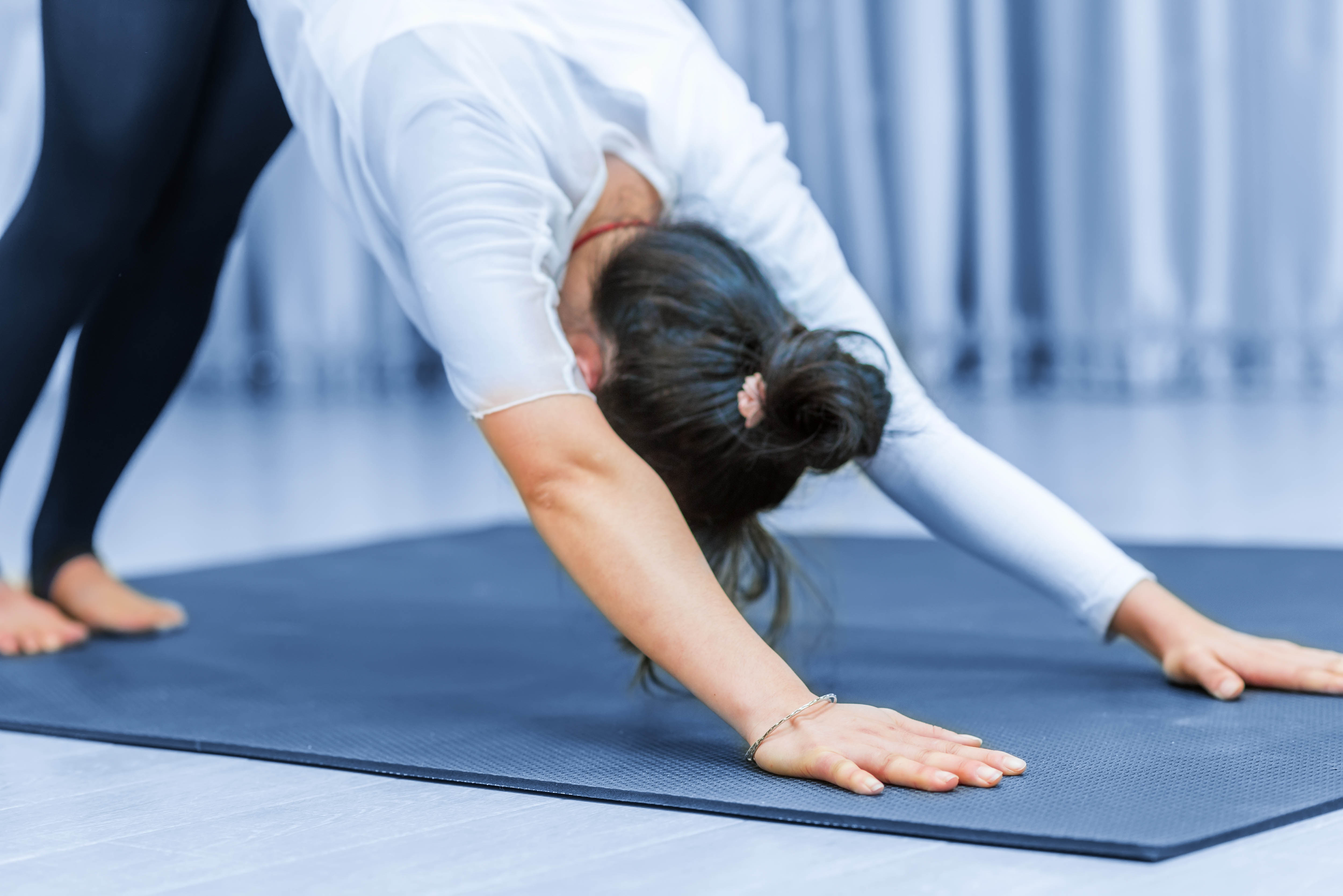 Young woman doing simple yoga - downward dog - pose